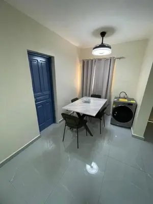 a room with a table and chairs and a blue door at Luxury apartment near Jumbo in San Pedro de Macorís