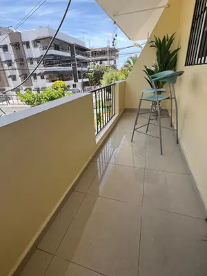 a balcony with a chair and a table at Beautiful Caribbean Coast Residence in Santo Domingo