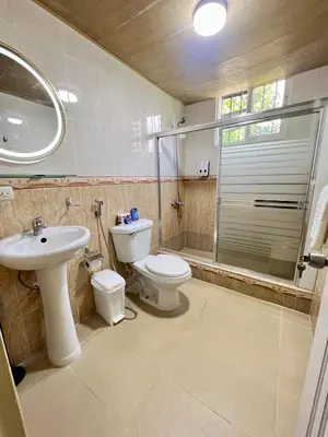 a bathroom with a toilet and a sink and a shower at Beautiful Caribbean Coast Residence in Santo Domingo