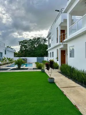 a yard with green grass next to a building at Apartamento en La Romana buena vista norte Jacuzzi in La Romana