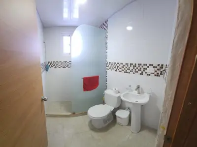 a bathroom with a toilet and a sink at Apartamento in Santo Domingo
