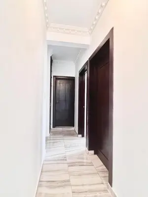 an empty corridor with black doors and white walls at Beautiful and confortable apt in Puerto Plata