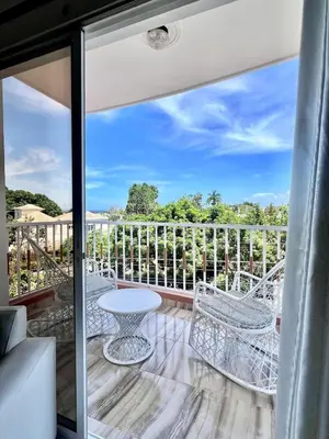 a patio with a table and chairs on a balcony at Beautiful and confortable apt in Puerto Plata