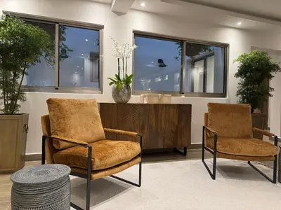 two chairs and a table in a room with windows at Caonabo35 Elegancia Boutique en Santo Domingo 2 in Santo Domingo