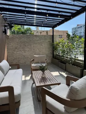 a patio with a table and chairs on a roof at Caonabo35 Elegancia Boutique en Santo Domingo 2 in Santo Domingo