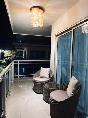 a balcony with two chairs and a chandelier at Experience Coconut Paradise Apart O2 in San Cristóbal