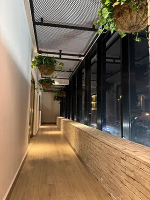 a corridor of a building with windows and plants at Caonabo35 Elegancia Boutique en Santo Domingo 3 in Santo Domingo