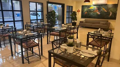a dining room with tables and chairs and a couch at Caonabo35 Elegancia Boutique en Santo Domingo 3 in Santo Domingo