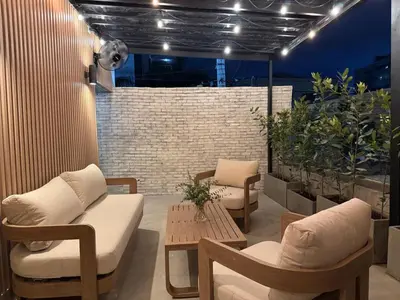 a patio with chairs and a table and lights at Caonabo35 Elegancia Boutique en Santo Domingo 5 in Santo Domingo