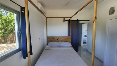 a small bed in a room with a window at Endless Horizon Apartments in Las Terrenas