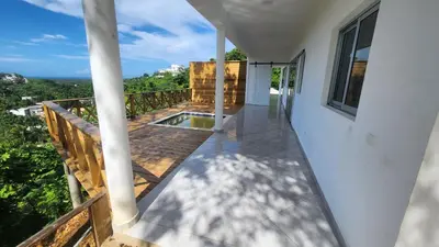 a balcony of a house with a swimming pool at Endless Horizon Apartments in Las Terrenas