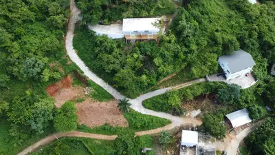 an aerial view of a road in a forest at Endless Horizon Apartments in Las Terrenas