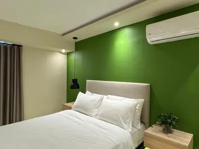 a bedroom with a green wall and a bed at Caonabo35 Elegancia Boutique en Santo Domingo 7 in Santo Domingo