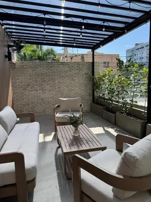 a patio with a table and chairs on a roof at Caonabo35 Elegancia Boutique en Santo Domingo 7 in Santo Domingo