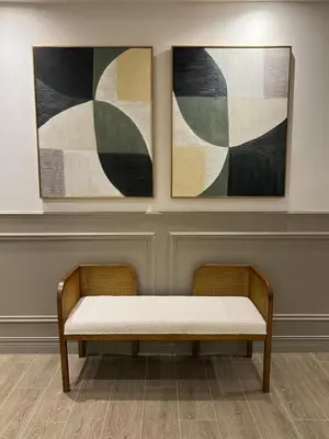 a bench in a gallery with two paintings on the wall at Caonabo35 Elegancia Boutique en Santo Domingo 8 in Santo Domingo