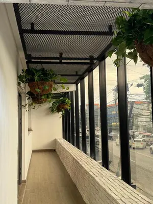 a balcony with potted plants on the side of a building at Caonabo35 Elegancia Boutique en Santo Domingo 8 in Santo Domingo