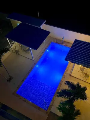 an overhead view of a swimming pool at night at Penthouse paradise by the beach! in La Romana