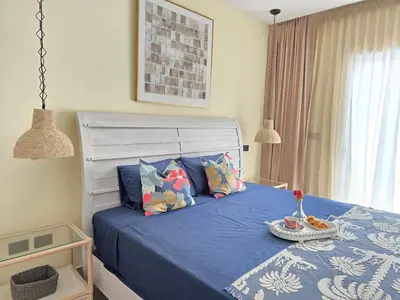 a bedroom with a bed with blue sheets and pillows at Dominica 203 Luxury Apartment by Caribbean Beach Dominicus Aqua Esmeralda in Bayahibe
