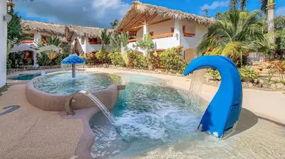 a water slide in the middle of a pool at Guest-Room 2 Palmeras - 2 Pax, 5 Min de La Playa in Las Galeras