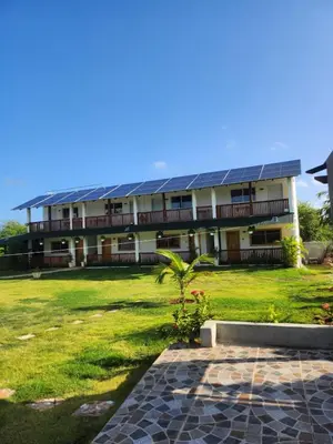 a building with solar panels on the side of it at Dani's Guesthouse in Las Galeras