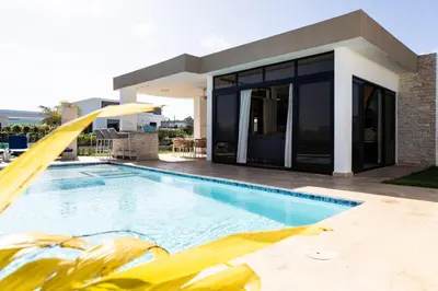a swimming pool in front of a house at Newly built 2 bedroom 2 bath private pool villa! in Sosúa