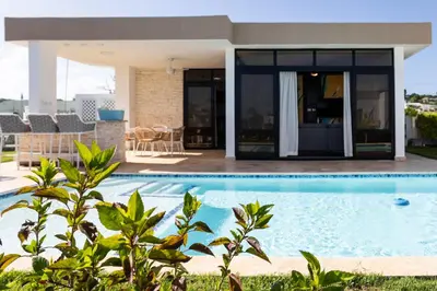 a swimming pool in front of a house at Newly built 2 bedroom 2 bath private pool villa! in Sosúa