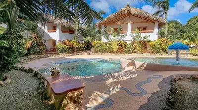 a house with a swimming pool in front of a house at Apartamento La Palmeras - 3 Pax, 5 Min de La Playa in Las Galeras