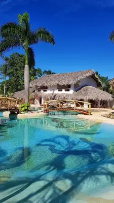 a resort with a swimming pool and a palm tree at Apartamento La Palmeras - 3 Pax, 5 Min de La Playa in Las Galeras