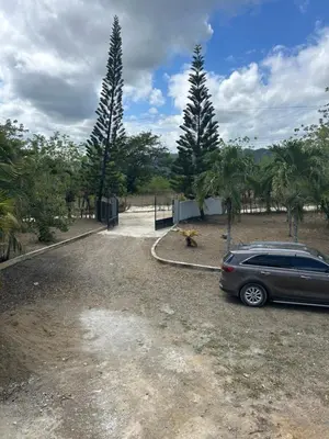 a car parked in a parking lot with palm trees at Villas Burnette in Camú