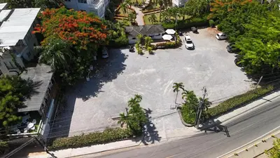 an aerial view of a parking lot with palm trees at La Fenice 3 Bedroom Beachfront Apartment in Las Terrenas