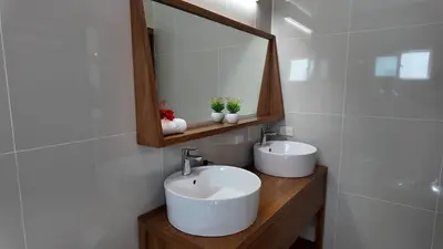 a bathroom with two sinks and a mirror at La Fenice 3 Bedroom Beachfront Apartment in Las Terrenas