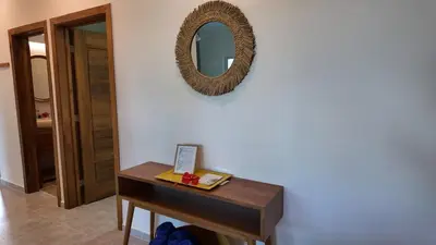 a mirror on a wall next to a table at La Fenice 3 Bedroom Beachfront Apartment in Las Terrenas