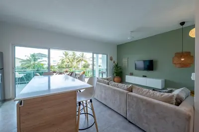a living room with a couch and a tv at La Fenice 3 Bedroom Beachfront Apartment in Las Terrenas