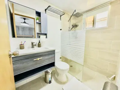 a bathroom with a toilet and a sink and a shower at Apartment 3 rooms terrace Wi-Fi Distrito Naciona in Pantoja