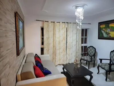 a living room with a couch and a table at Apartamento Confortable Moderno Minimalista in Ciruelitos Arriba