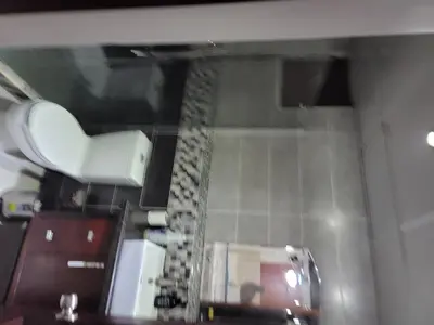 a bathroom with a toilet and a shower curtain at Apartamento Confortable Moderno Minimalista in Ciruelitos Arriba