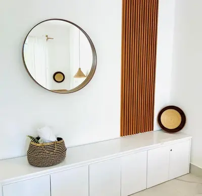 a mirror on a white wall above a white cabinet at Beachside Studio with Pool, Steps to Playa Bonita in Las Terrenas