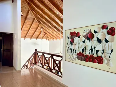 a painting of shoes on a wall in a hallway at Hilltop Dominican Villa with Pool and Big Terrace in Las Terrenas