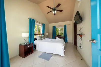 a bedroom with a bed and a ceiling fan at Space Freedom Connection in Sosúa