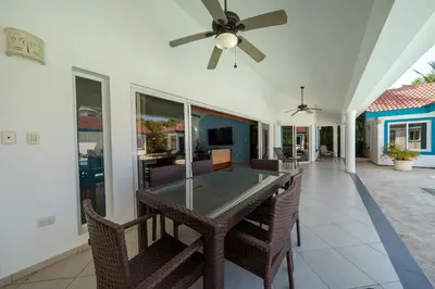 a dining room with a table and chairs and a ceiling fan at Space Freedom Connection in Sosúa
