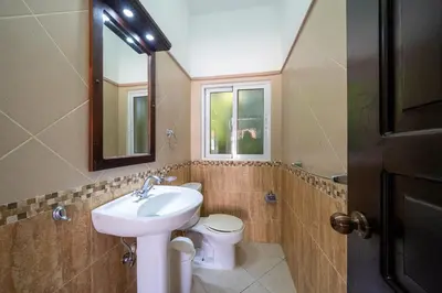a bathroom with a sink and a toilet and a mirror at Space Freedom Connection in Sosúa