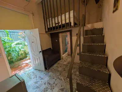a staircase in a room with a door and a stair case at Casa de huéspedes La Española in Santo Domingo