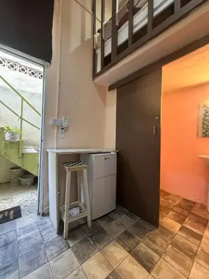 a kitchen with a counter and a stool in a room at Casa de huéspedes La Española in Santo Domingo
