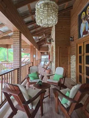 a living room with chairs and a chandelier at Villa Doña Macha