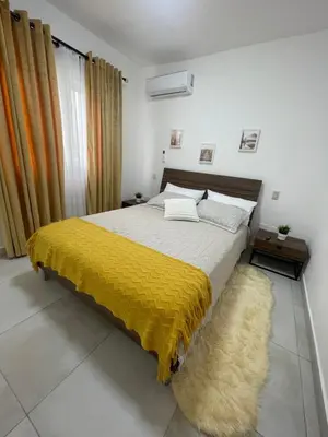 a bedroom with a bed with a yellow blanket on it at WRparaiso in Boca Chica