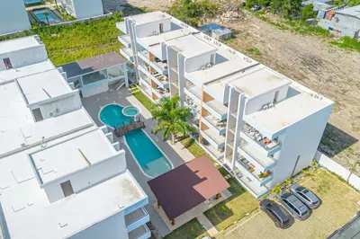 an aerial view of a white building with a pool at Caribbean Pearl 2BR Sunshine Bayahíbe in Bayahibe
