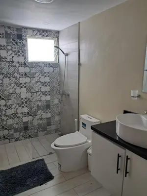 a bathroom with a toilet and a sink and a shower at Torre san geronimo 1109 apartamento 10-06 in Santo Domingo