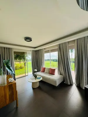 a living room with a couch and a table at Villa Paraíso Casa de Campo in La Romana