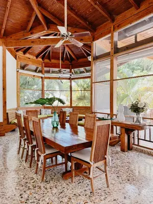a dining room with a wooden table and chairs at Lux Villa Casa de Campo in La Romana