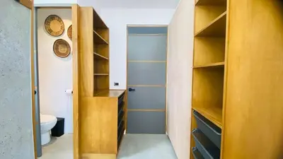 a bathroom with wooden shelves and a toilet in a room at Private Pool Villa With Parking in Las Terrenas